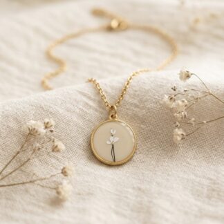 Collier médaillon beige et fleur dorée et blanche