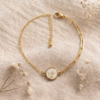 Bracelet médaillon blanc et petite fleur dorée