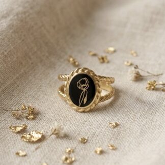 Bague rétro noire et petite fleur dorée
